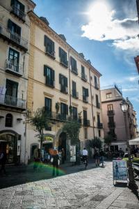 a group of people walking in front of a building at B&B Luxury Salerno Central in Salerno