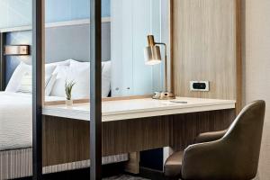 a bedroom with a mirror and a chair at SpringHill Suites by Marriott Bryce Canyon in Bryce Canyon +1 photo