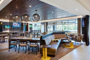 a restaurant with a couch and tables and chairs at SpringHill Suites by Marriott Bryce Canyon in Bryce Canyon