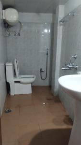 a bathroom with a shower and a toilet and a sink at Hotel Best Inn in Darjeeling +25 photos