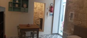 a small dining room with a table and a door at DaDa' Home in Trani