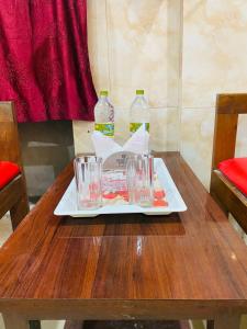 a tray with two bottles of water on a wooden table at Hotel Best Inn in Darjeeling