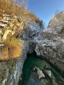 a pool of emerald green water in a canyon at Le Nid de Chartreuse in Saint-Christophe