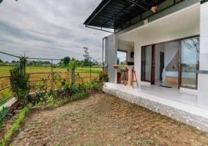 a house with a view of a field at Putra House Ubud in Ubud