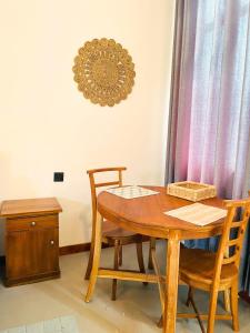 a dining room table and two chairs and a clock on the wall at Crystal Pearl Villa, Weligama - 3min to beach in Weligama +20 photos