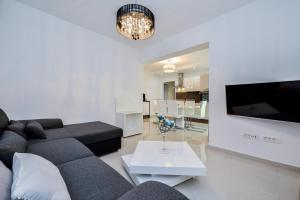 a living room with a couch and a tv at Luxury Apartment 1 Villa Arta in Bibinje