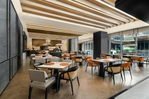 a dining room with tables and chairs in a restaurant at Xi'an Marriott Hotel High-Tech Zone in Xi'an