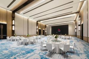 a banquet hall with white tables and white chairs at Xi'an Marriott Hotel High-Tech Zone in Xi'an +55 photos