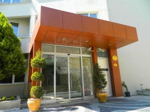a facade of a building with a large orange structure at Hotel Baylan İzmir in Izmir