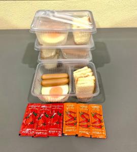 a plastic lunch box with food and snacks on a table at Sai Klong Song Lae Resort Pakpra Phatthalung in Phatthalung