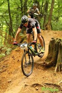 a man riding a bike down a dirt trail at Chambres d'H&ocirc;tes Aux Tournesols in Malauc&egrave;ne
