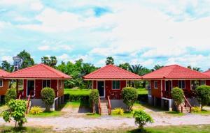 a row of houses with red roofs at Sai Klong Song Lae Resort Pakpra Phatthalung in Phatthalung +9 photos