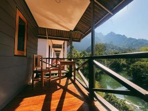 a balcony of a house with a view of a river at Thavisok Guest House in Nongkhiaw +27 photos