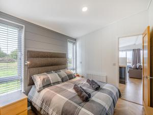 a bedroom with a large bed with two pillows on it at Billy Goat Lodge in Crossway Green +14 photos