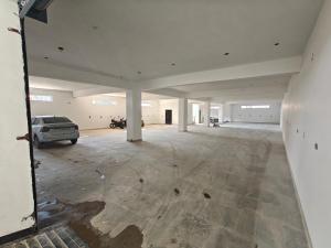 an empty garage with a car parked in it at Hotel Nandaashish in Haldwāni +2 photos