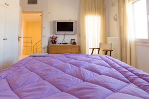 En eller flere senge i et værelse på Villa Voutes
