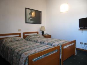 Postel nebo postele na pokoji v ubytování Hotel Rizzi