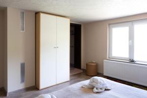a bedroom with a large white closet and a window at The Bird Villa in Bosnek +242 photos