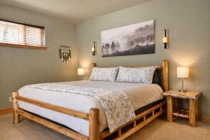 a bedroom with a large bed with two night stands at River Song Cabin home in Leavenworth