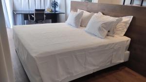 a bed with white sheets and pillows on it at Costa do Sauípe - Reserva Sauípe in Costa do Sauipe +39 photos