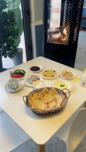 a table with a pie and other food on it at Badan Suites & Hotel in Amman