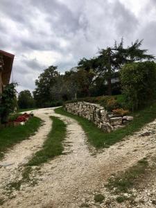 a dirt road next to a stone wall at Campo della Corte in Castelpagano