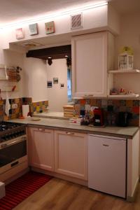 a kitchen with white cabinets and a stove at Lo Struzzo in Bagno di Romagna