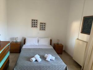 a bedroom with a bed with two pillows on it at Reposo in Nikolítsion