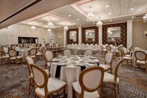 a banquet room with tables and chairs and chandeliers at Holiday Inn Lancaster by IHG in Lancaster