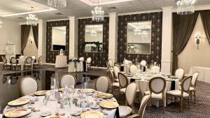 a banquet room with tables and chairs and chandeliers at Holiday Inn Lancaster by IHG in Lancaster