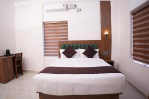 a bedroom with a large bed in a room at Pearl Suites in Cochin