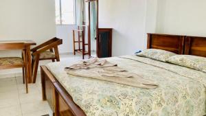 a bedroom with a bed with a blanket on it at New Verona Hotel in Wennappuwa +63 photos
