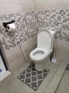 a bathroom with a toilet with a rug next to it at Serene Villa in Grand-Baie +12 photos