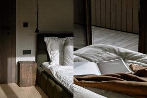 a bedroom with a bed with a laptop on it at BAUA Gartenhaus in Maurach