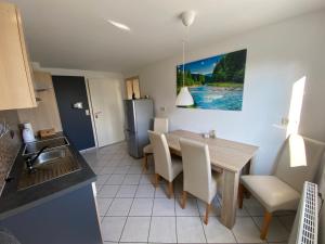 a kitchen and dining room with a table and chairs at Grünes Allgäu in Opfenbach