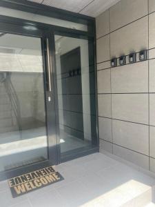 a glass door with a welcome sign in a building at EVEREST 33 Garsoniera in Bucharest +15 photos
