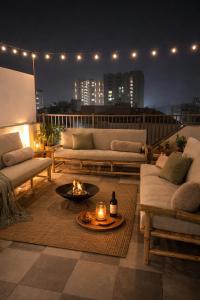 a living room with couches and a fire pit on a balcony at Chérie Bliss Loft in Jaipur