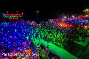 a large crowd of people at a party at night at Paradise Bungalows in Haad Rin +37 photos