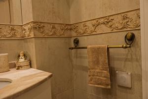 a bathroom with a sink and a towel at Апартамент за гости Марица in Asenovgrad