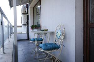 a kitchen with two chairs and a table with blue pillows at Апартамент за гости Марица in Asenovgrad