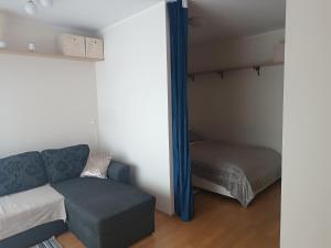 a small room with a couch and a bed at Jõekalda kodu in Pärnu