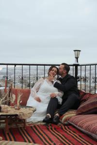 a bride and groom sitting on a couch at Kismet Cave Mansion in Göreme