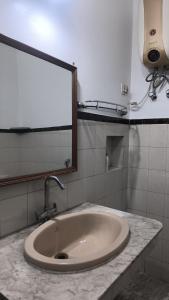 a bathroom with a sink and a mirror on a counter at Royal Inn in Lucknow +4 photos