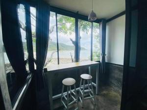 a room with a counter and two stools in front of a window at Family view A3 -Kantiang paradise resort- in Ko Lanta +13 photos