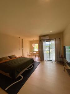 a bedroom with a bed and a sliding glass door at Oceanchild Khaolak in Khao Lak +22 photos