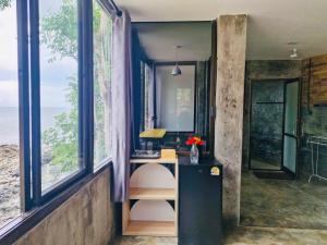a home office with a desk and large windows at Family view A3 -Kantiang paradise resort- in Ko Lanta