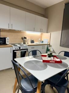 a kitchen with a white table and chairs in a kitchen at Beauty Home Orestiada Center in Orestiada