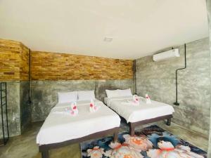 two beds in a room with white sheets at Family view A3 -Kantiang paradise resort- in Ko Lanta