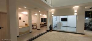 a large room with a kitchen and a dining room at Sandy Blooms in Ukulhas