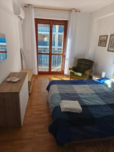 a bedroom with a bed and a desk and a window at Il nido Perugia in Perugia
